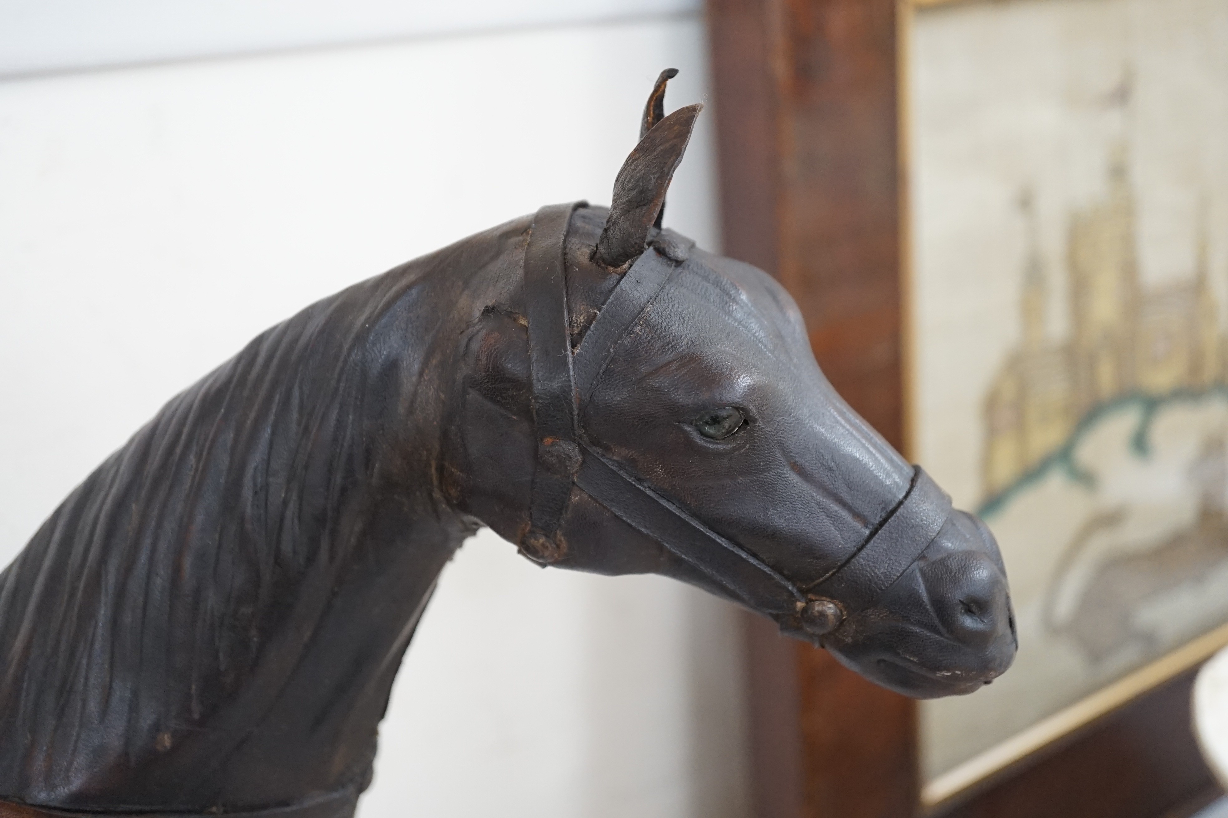 Two finely modelled horses made from brown leather, tallest 49 cms high